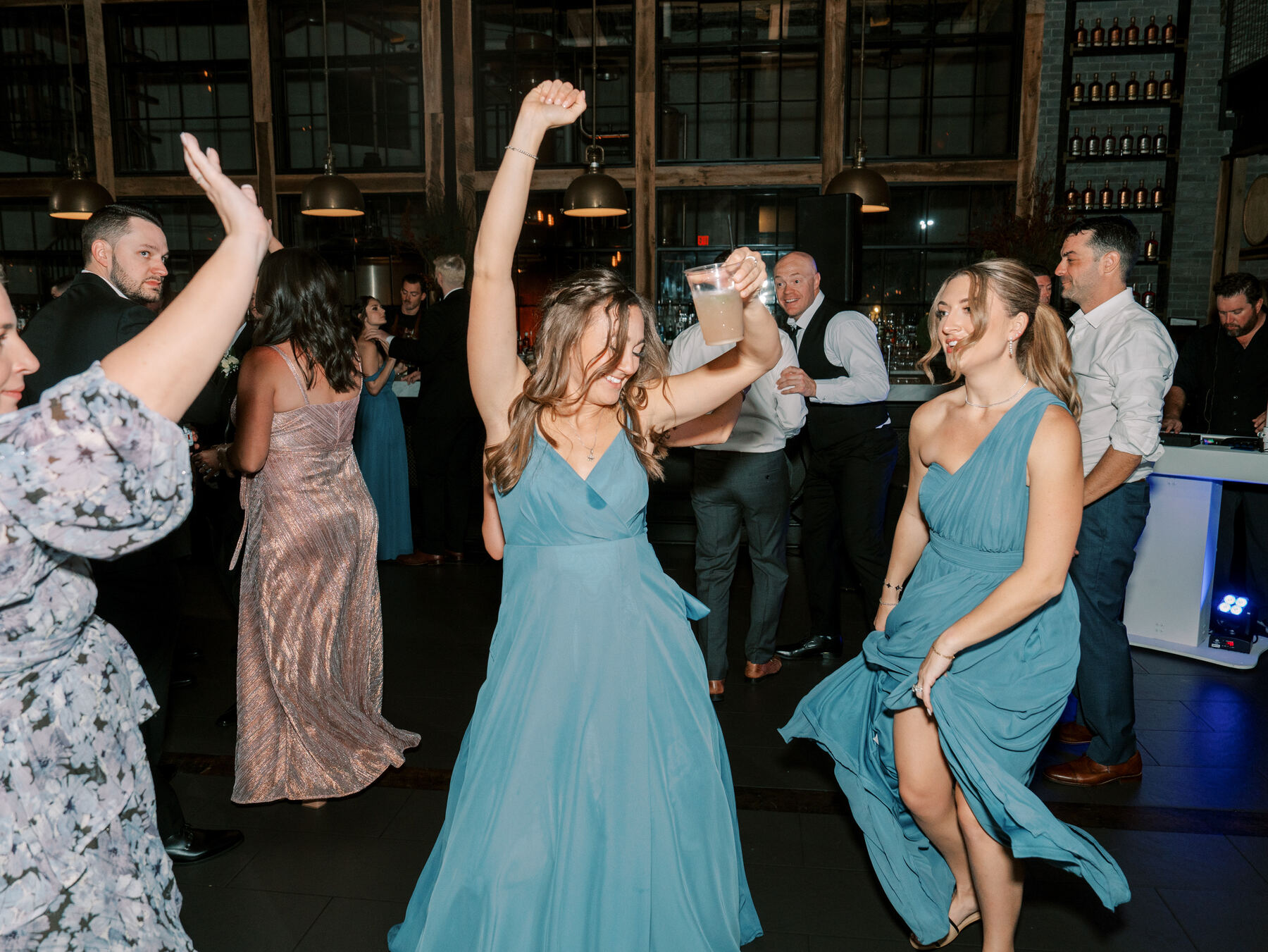 Bridesmaids cheering during a heartfelt reception toast